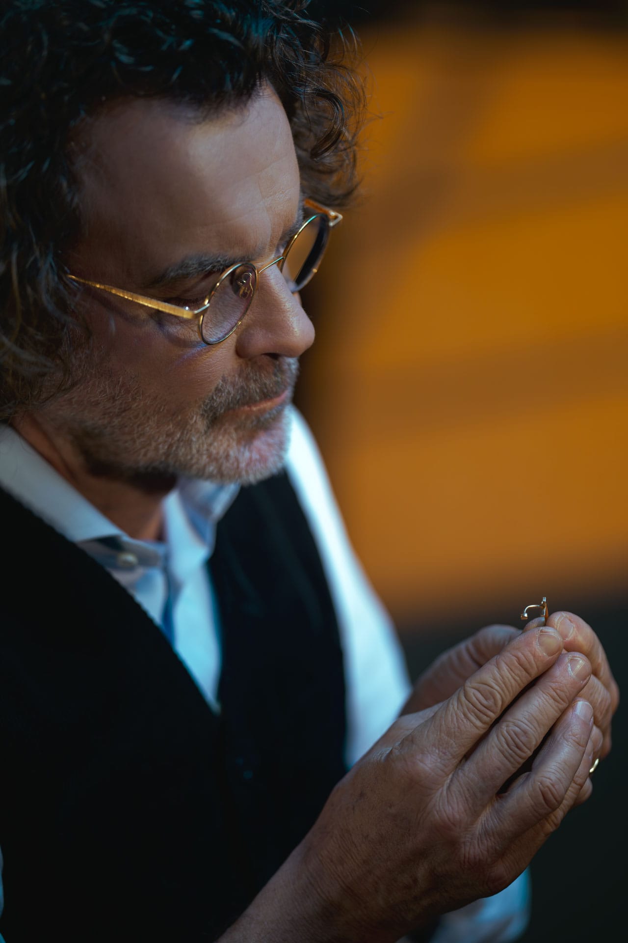 Roberto Novello examining a small gold piece